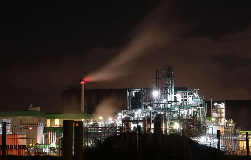 Complex network of industrial pipes and machinery inside a Lisbon plant.